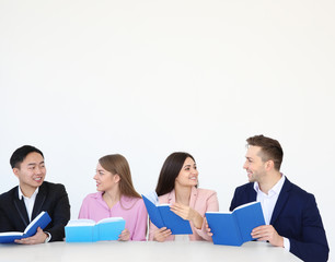 Wall Mural - Group of people reading books while sitting at table