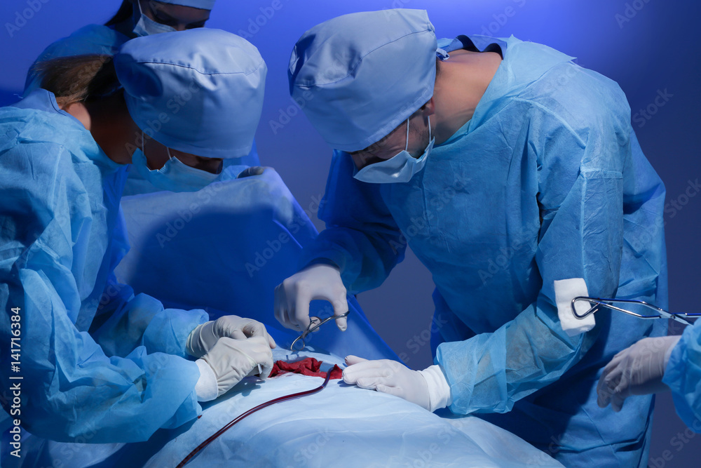 Surgeons operating patient in clinic