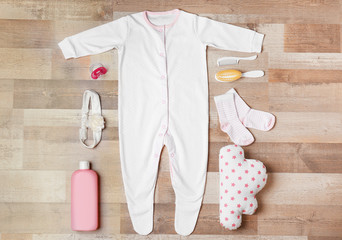 Wall Mural - Baby clothes and accessories on wooden background