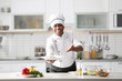 © Africa Studio - Mature Indian chef cooking in kitchen