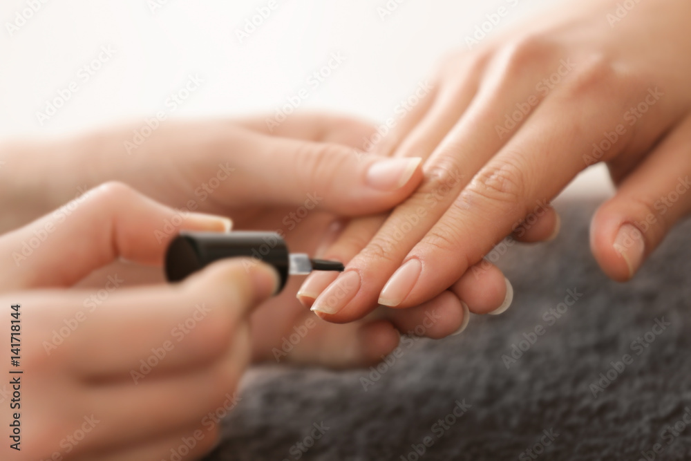 Young woman having hand treatment in spa salon