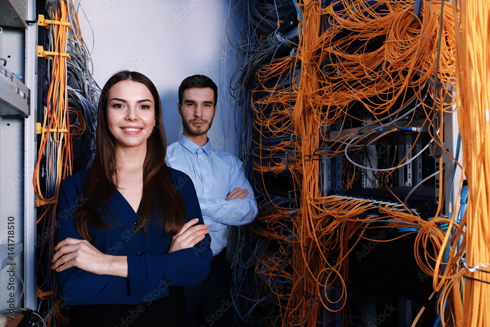 Young engineers in modern server room