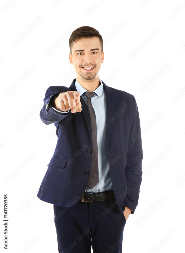 Handsome businessman in elegant suit pointing on white background