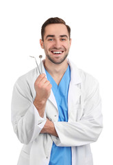 Poster - Handsome young dentist with tools on white background