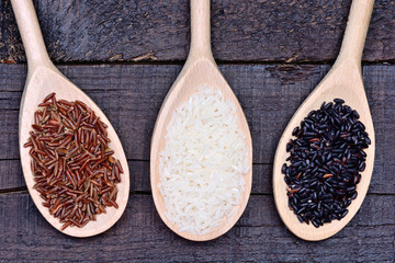 Wall Mural - Wooden spoons with various type of rice