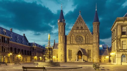 Wall Mural - Illuminated gothic facade of Ridderzaal or Hall of Knights in Binnenhof, Hague, Netherlands (static image with animated sky)
