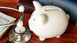 Stethoscope, piggy bank and cash. Affordable health care concept.
