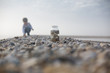 © Sarah Rypma - Boy collecting pebbles on beach