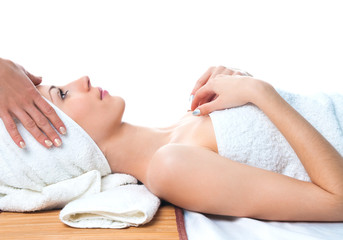 Wall Mural - beautiful young woman having massage in spa lying on table