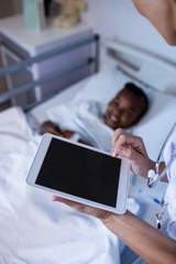 Poster - Female doctor using digital tablet during visit in ward