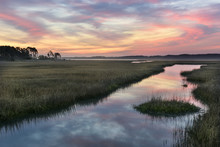 Clouds Refecting In Water Of Salt Marsh At Sunrise.
