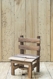Fototapeta  - mini model chair with wooden wall