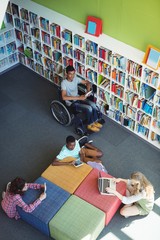 Wall Mural - Attentive students studying in library