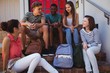© WavebreakMediaMicro - Students interacting with each other on staircase
