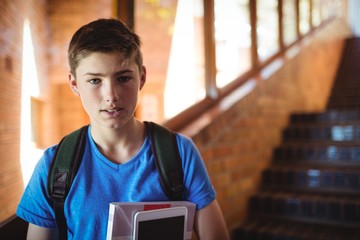 Wall Mural - Portrait of schoolboy holding digital tablet 