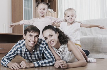 Wall Mural - Relaxed family in domestic interior