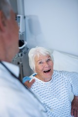 Canvas Print - Doctor interacting with senior patient in ward