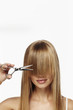© sanneberg - Beautiful blond about to cut fringe, studio