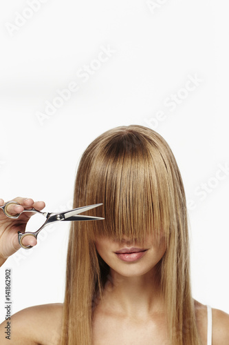 Fotografie, Obraz Beautiful blond about to cut fringe, studio