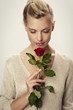 © sanneberg - Beautiful woman holding red rose, studio