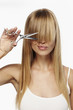 © sanneberg - Scissor girl about to cut long blond hair, studio