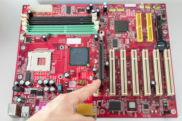 Pointing to the  Graphics Card channel
A mainboard ( Main board,cpu motherboard,logic board,system board or mobo board)
close up of electronics circuit board 