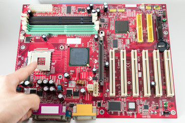 Pointing to the CPU
A mainboard ( Main board,cpu motherboard,logic board,system board or mobo board)
close up of electronics circuit board 