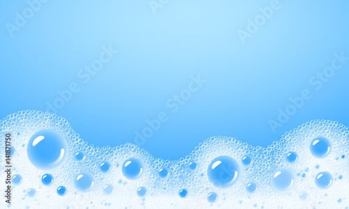 Fotografía Soap foam overlying on the background of a blue water color