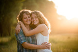 Fototapeta Miasto - Daughter and mother hugging each other