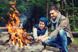 © Syda Productions - father and son roasting marshmallow over campfire