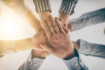 Hands stacked in a pile. A symbol of teamwork and trust.