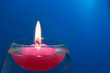 Floating candle on a bright colored background