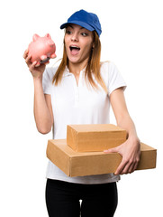 Wall Mural - Surprised Delivery woman holding a piggybank