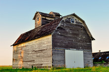 A Venerable, Veteran Barn Provides Storage In A Field Near Hinckley, Illinois. A Notable Contrast On The Barn Is The Newly Fashioned Corrugated Metal Door.