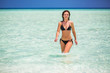 © sborisov - Attractive young woman enjoys Maldivian beach walking in the ocean water