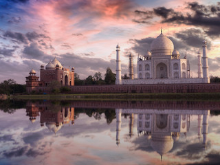 Fototapete - Taj Mahal at sunset with vibrant sky and reflections on the water of the Yamuna river. Photograph taken from Mehtab Bagh Agra.
