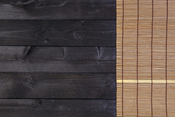 Wall Mural - Bamboo mat for sushi on wooden background. Top view with copy space