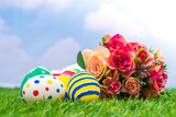 Fototapeta Zwierzęta - Easter eggs with artificial flower on Fresh Green Grass