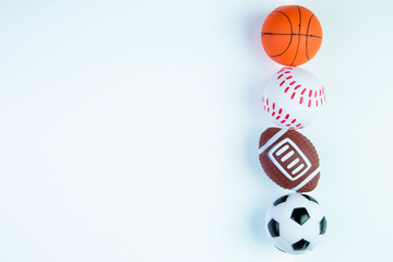  Football toy, Baseball toy, Basketball toy and Rugby toy isolated on white background with copy space.Concept winner of the sport.