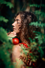 Wall Mural - beautiful young woman in forest with apple portrait