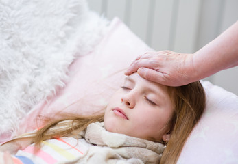 mother touches the forehead of the child, checking the temperature