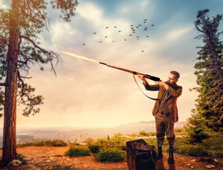 Poster - Duck hunter in hunting clothing aims an old rifle