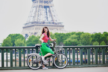 Canvas Print - Woman riding a bicycle on a street of Paris