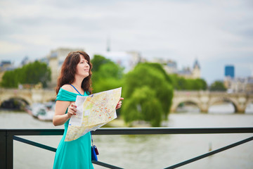 Wall Mural - Young woman with map in Paris