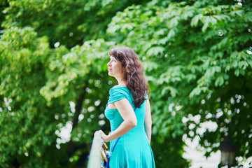 Canvas Print - Beautiful young woman walking in Parisian Tuileries park