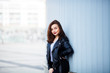 © chichkaua - Fashion hipster woman posing outdoor. leather jacket,brunette hair, bright red lips.Street fashion concept.
