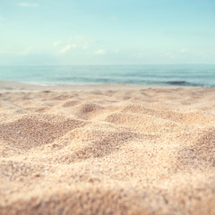 Wall Mural - Sand beach tropical with blurred sea sky and sunny background, summer day, copy space or for product.