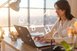 © undrey - Woman at workplace using laptop working, typing, surfing the internet
