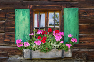 Wall Mural - Window of a wooden mountain hut in the alps