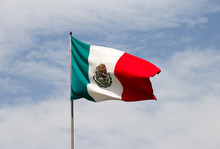 Mexican Flag And Blue Cloudy Sky